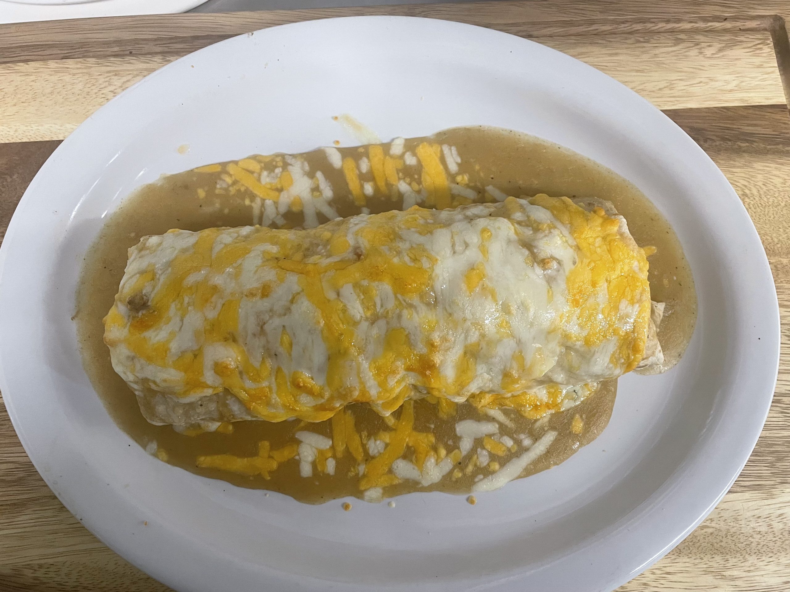 Big James Burrito topped with cheese sauce, served with rice and beans at Anita's Tex-Mex