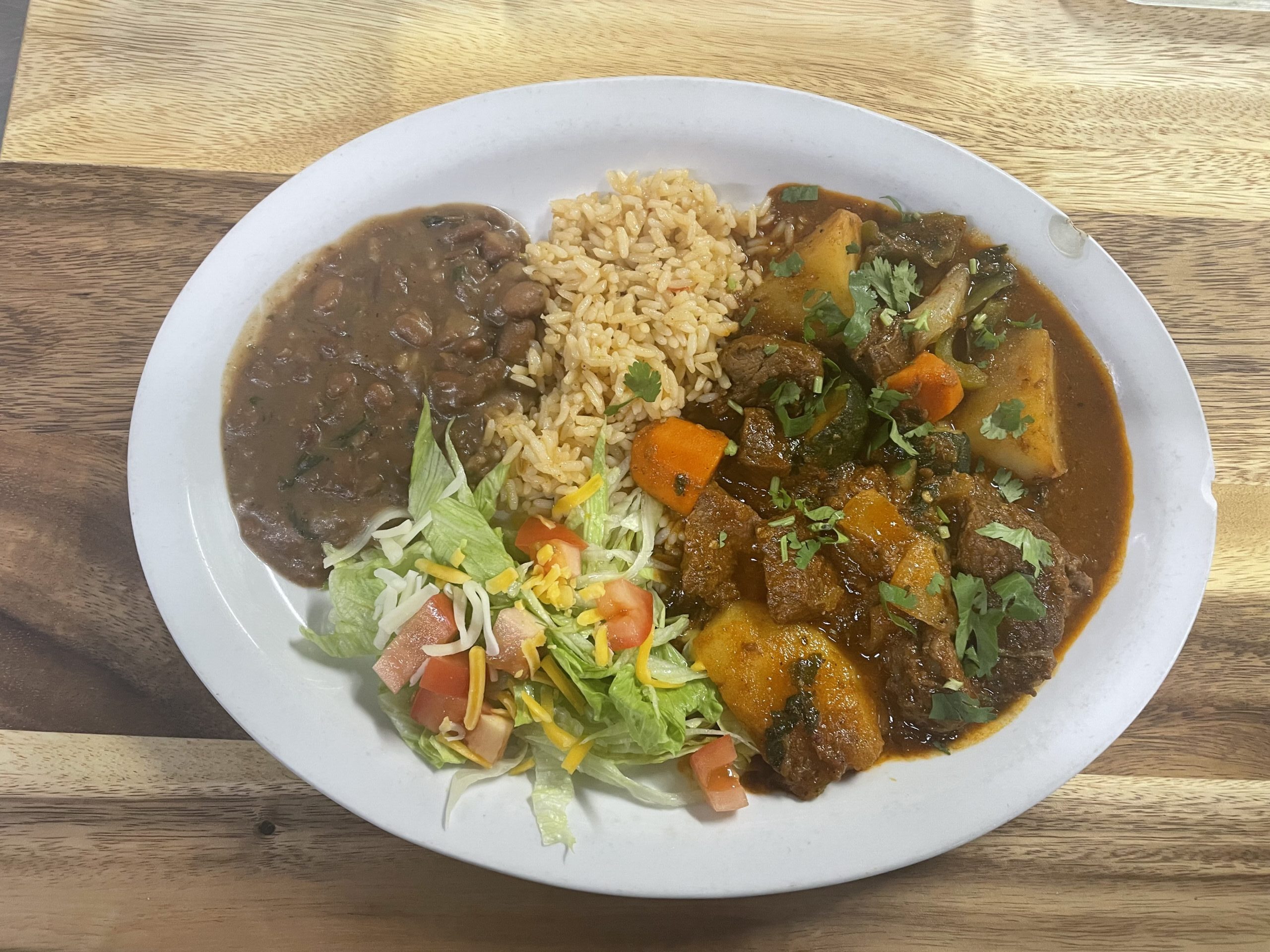Carne guisada served with rice, beans, and salad at Anita's Tex-Mex