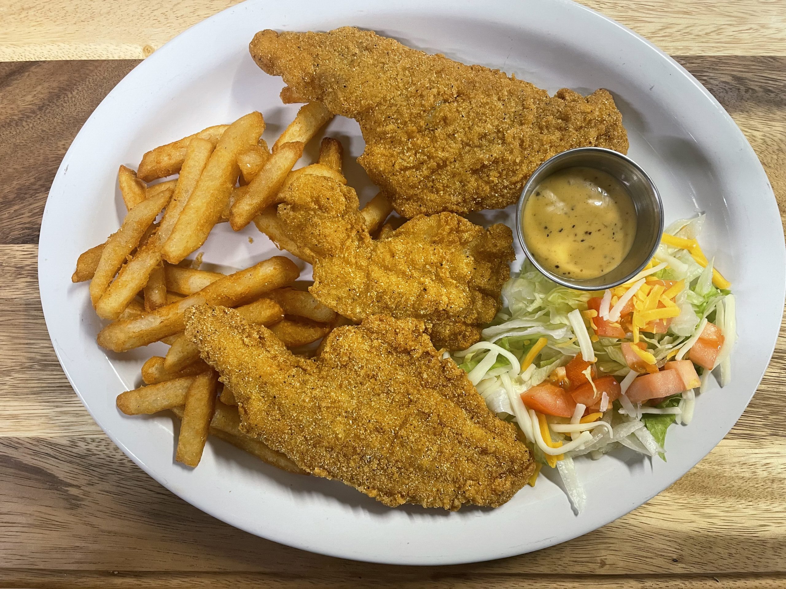 Fried catfish dinner with French fries and salad at Anita's Tex-Mex